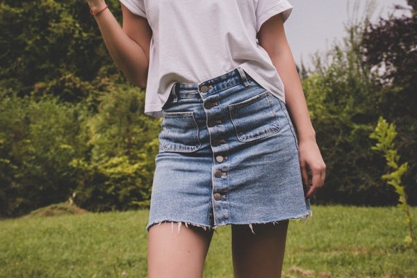 girl in button jeans skirt